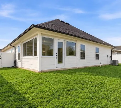 After: the same porch enclosed with white-framed windows and a glass door.